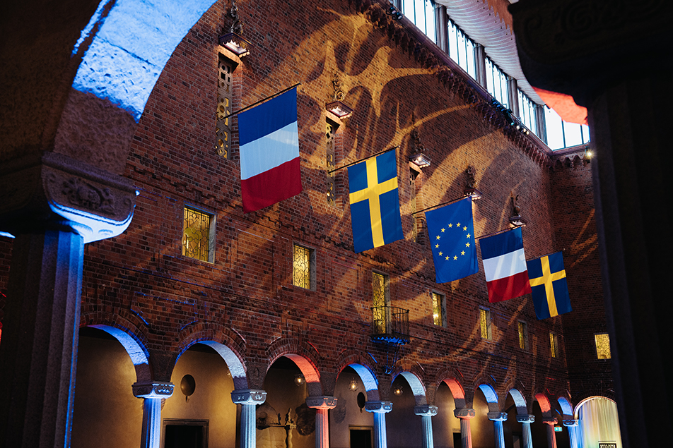 The interior of Stockholm City Hall, decorated with flags.