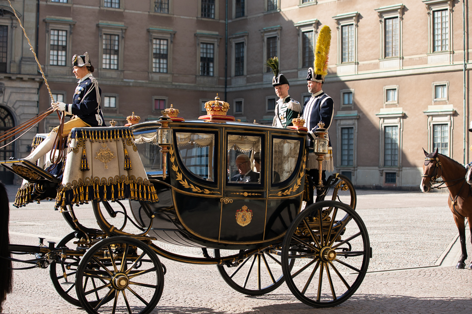 The King and Queen leave the Royal Palace in one of the Royal Stables' carriages. 