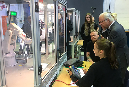 Elever från Mälardalens Tekniska Gymnasium ger Kungen en demonstration av robotar. 