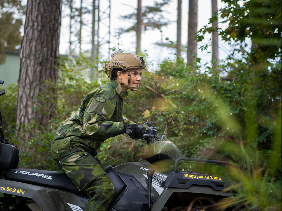 The Crown Princess drives a six-wheel drive ATV on the Parachute Rangers' off-road course at Karlsborg.