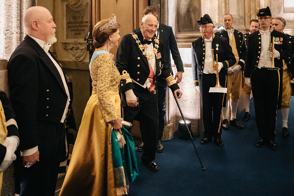 The Queen was accompanied to the table by The King of Norway. 