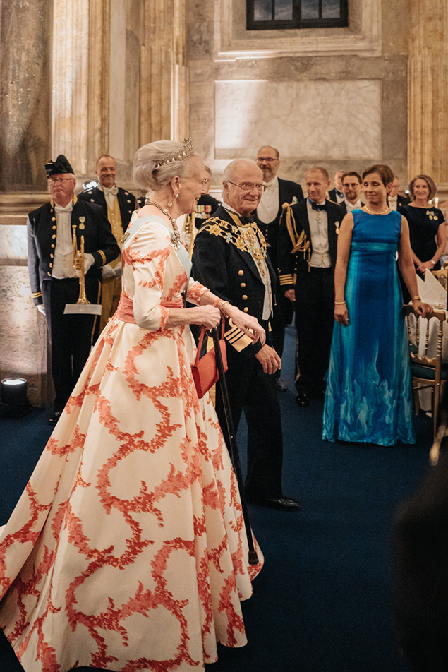 The King accompanied The Queen of Denmark to the table. 